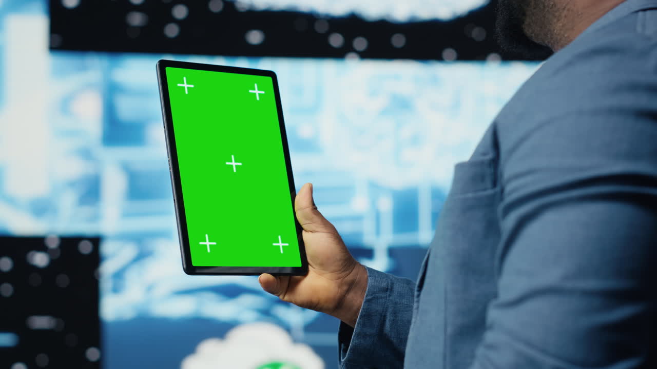 Black IT specialist examining algorithmic data next to chroma key