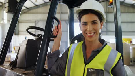 portrait of happy worker standing near forklift 4k