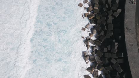 Smooth-Waves-Crashing-On-Rocks-Of-Marina-Pier,-Puerto-De-La-Cruz,-Spain