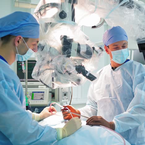 doctors perform neurosurgery. surgeon consults female specialist in the operating room. medical workers operate the patient in modern hospital.