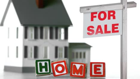 animation of house for sale sign and home text on falling cubes over house on white background