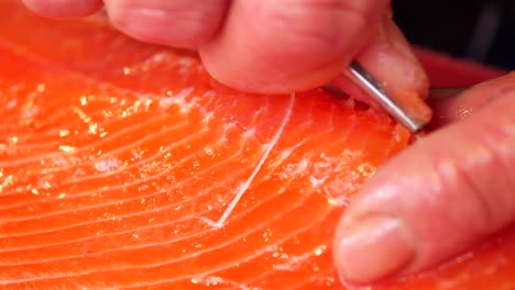 close-up of a fresh salmon fillet being prepared for cooking