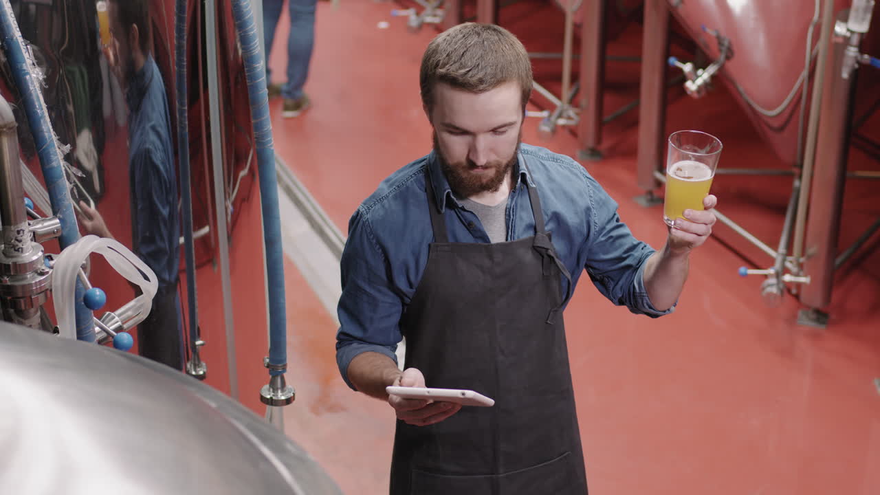Brewery Supervisor Checking Produced Beer