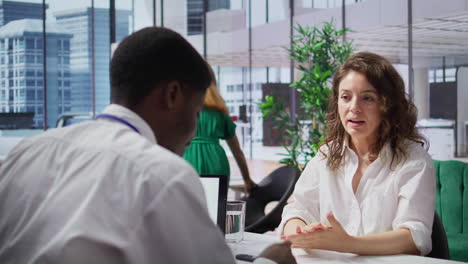 recruiter interviewing job applicant to learn about her qualifications and skill