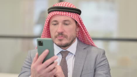 portrait of arab businessman using smartphone