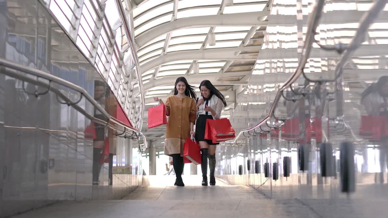 una joven hermosa haciendo compras juntos en la ciudad. una dama con una bolsa de compras roja en las manos.