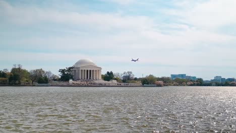 An-airplane-flying-past-the-jefferson-memorial