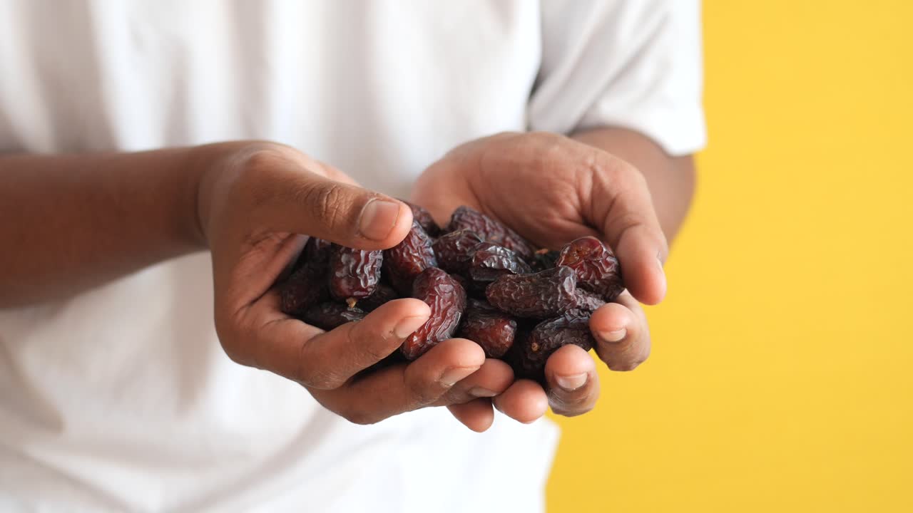 Men holding fresh date fruits