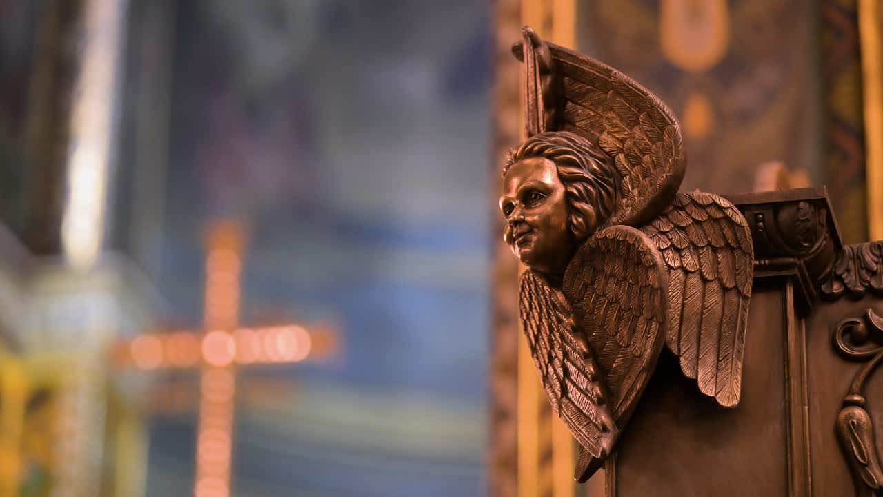 A solemn, serene atmosphere inside Kyiv's St. Volodymyr's Cathedral. This intimate shot focuses on a detailed angel, a divine messenger, as a cross of faith glows softly in the background.