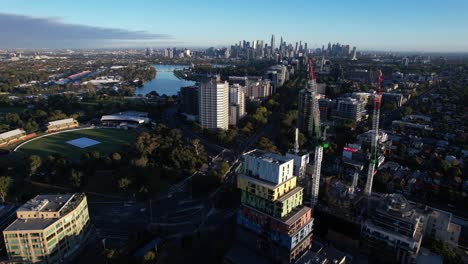 big main road leads to melbourne downtown, dramatic aerial orbit in sunset