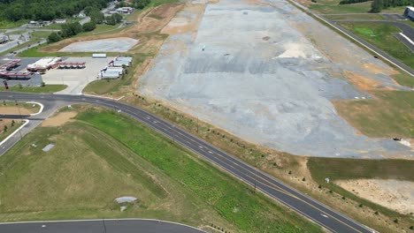 Aerial-drone-view-of-business-park-that-includes-factories,-warehouses,-and-gas-station