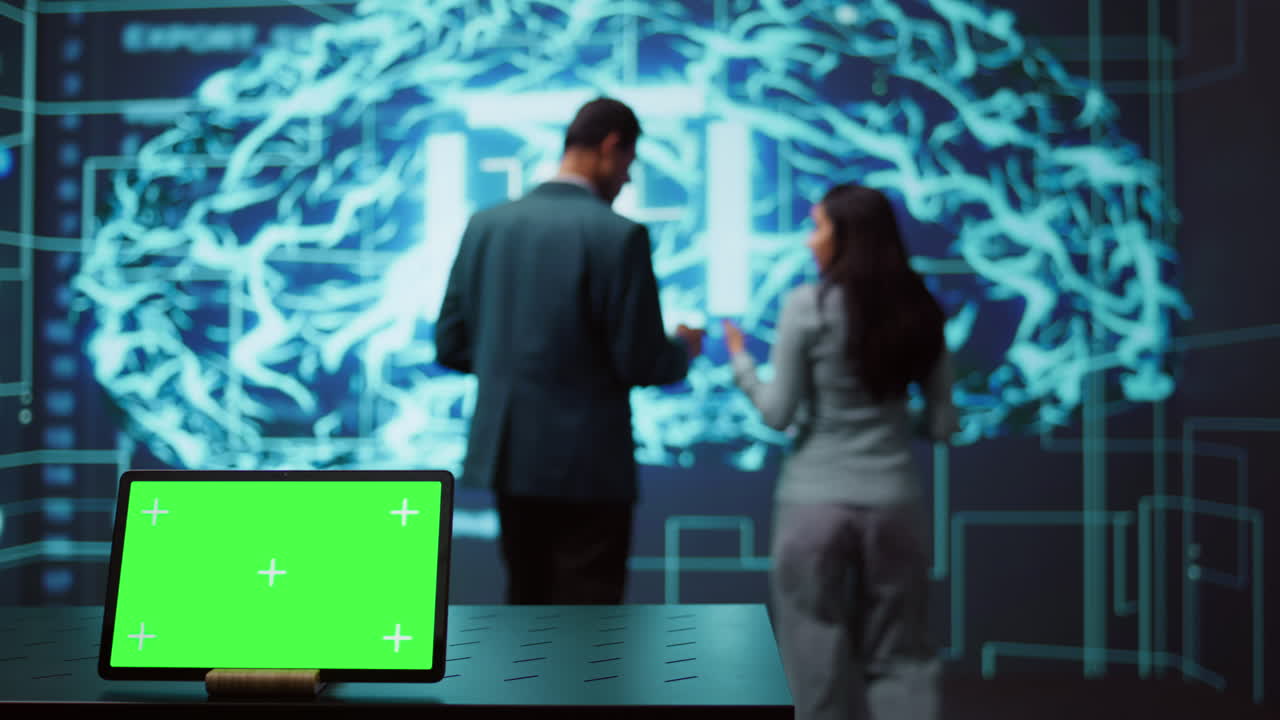 IT experts in high tech location work on chroma key notebook