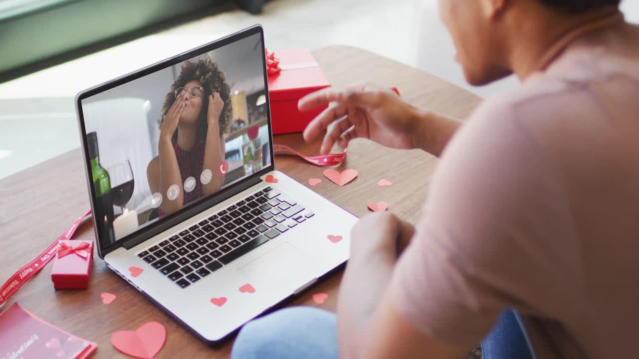 Happy african american woman kissing and making valentine's day video call on laptop