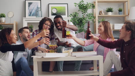 friends celebrating with pizza and drinks