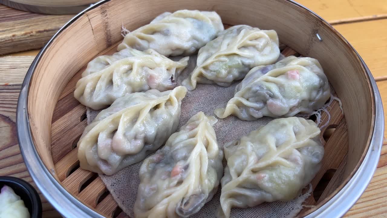 Steamed vegetable dumplings in bamboo steamer close up
