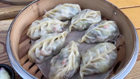 steamed vegetable dumplings in bamboo steamer close up