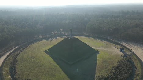 aerial of austerlitz pyramid in the netherlands on a sunny day - drone flying backwards