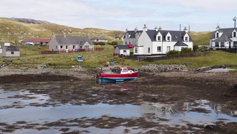 Static-shot-of-a-fishing-boat-beached-on-the-shore-on-the-Isle-of-Scalpay