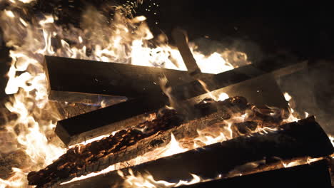 4k video of wood being added to a bonfire