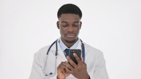african doctor browsing smartphone on white background