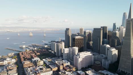 Soar above downtown San Francisco with this aerial video, featuring the Bay Bridge and the city&#039;s architectural marvels bathed in the warm glow of the setting sun