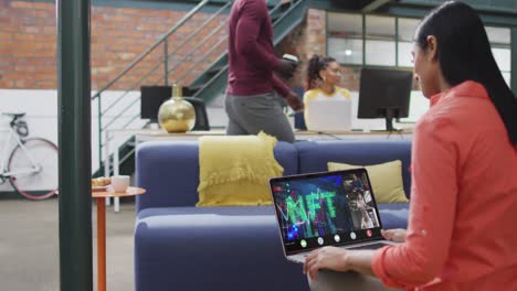 Biracial-businesswoman-using-laptop-for-video-call-with-diverse-business-colleagues