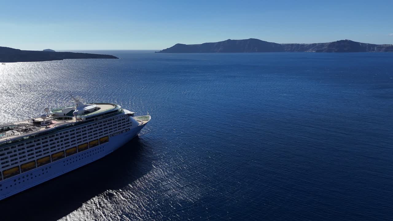 cruise ship waits for holiday travelers to return from a Mediterranean sun-soaked vacation on Santorini, Greece