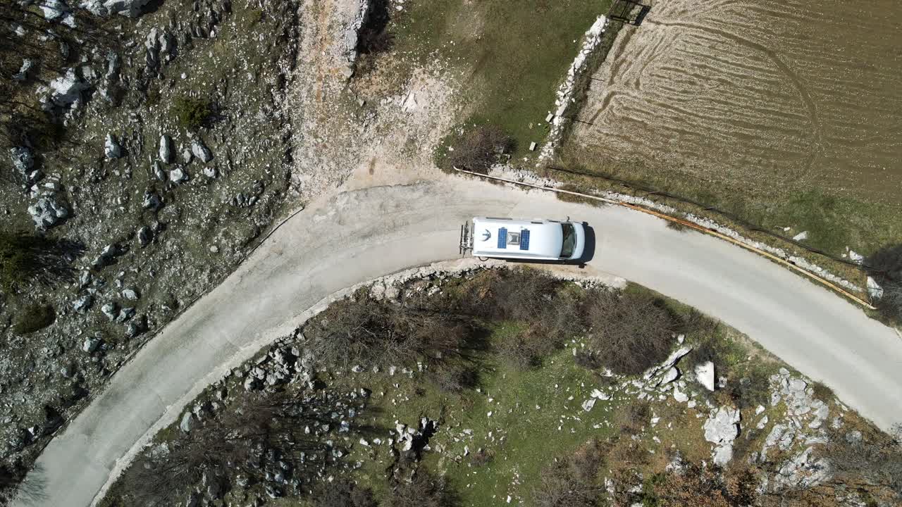 Top down aerial view of RV driving a curve road, Park Prirode Biokovo, Croatia