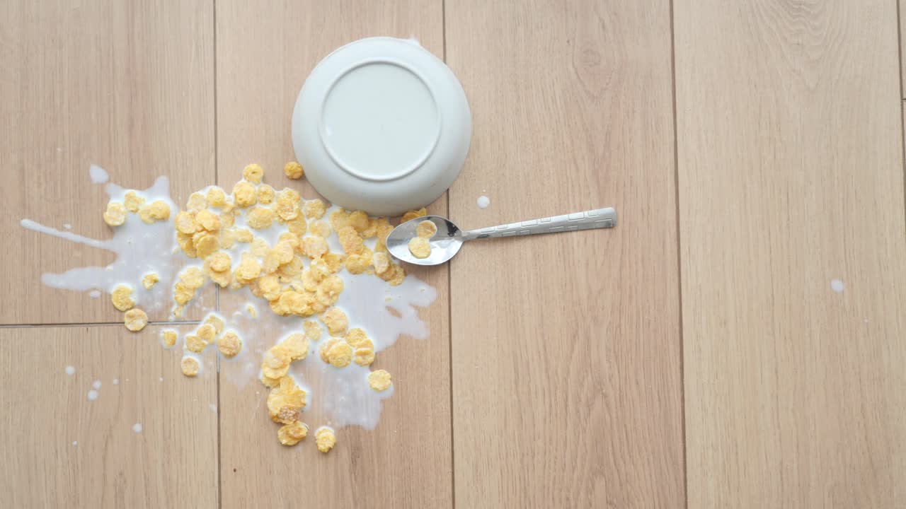Spilled Cereal and Milk on Wooden Floor