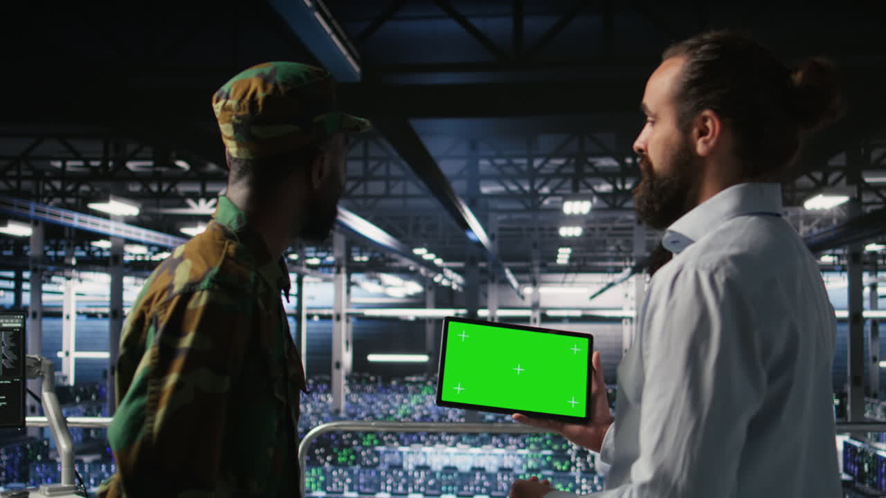 Military technicians in data center use green screen mockup tablet