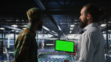 military technicians in data center use green screen mockup tablet
