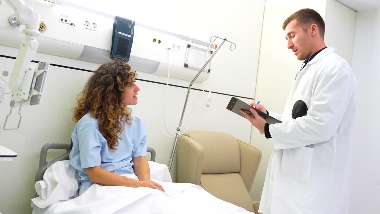 Doctor Consulting with Patient in Hospital Bed