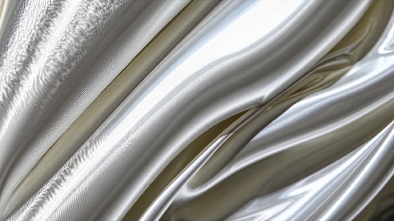 Video ravvicinato di un tessuto di seta bianca liscio e fluttuante, che mostra la sua texture lucida e pieghe eleganti.