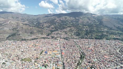 high-altitude aerial shot of huaraz, peru, showcasing the city's vast urban sprawl surrounded by andean mountains. a perfect stock image for urban planning, tourism, and environmental topics