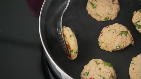 close-up of frying delicious crab cakes in a pan