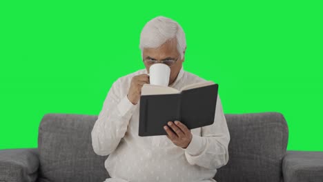 Indian-old-man-reading-book-and-drinking-tea-Green-screen