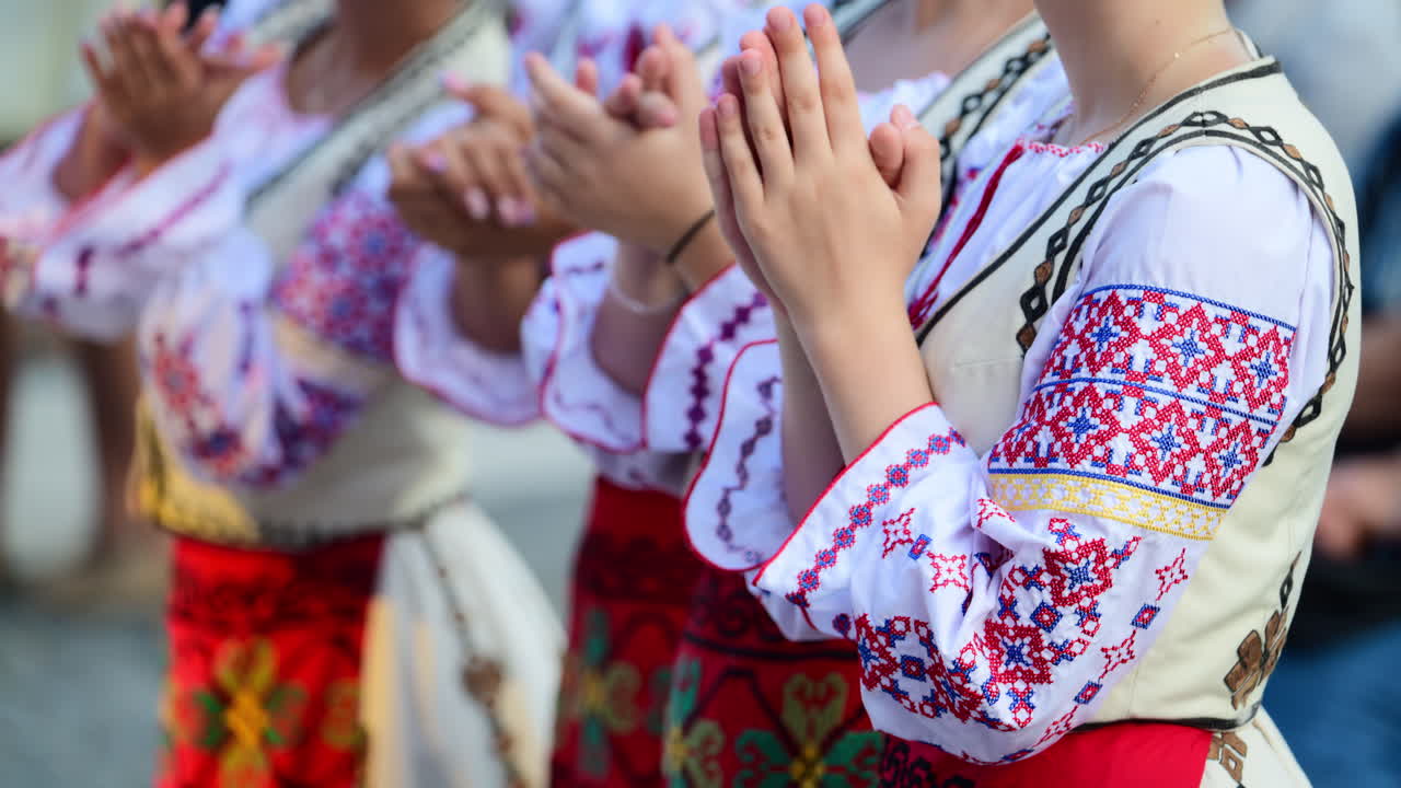 Dancers in traditional Moldavian and Romanian attire perform lively folk dances, displaying colorful costumes and elegant movements