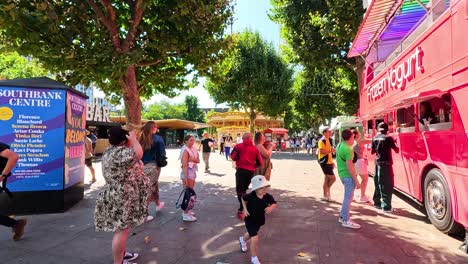 people dancing near a pink bus