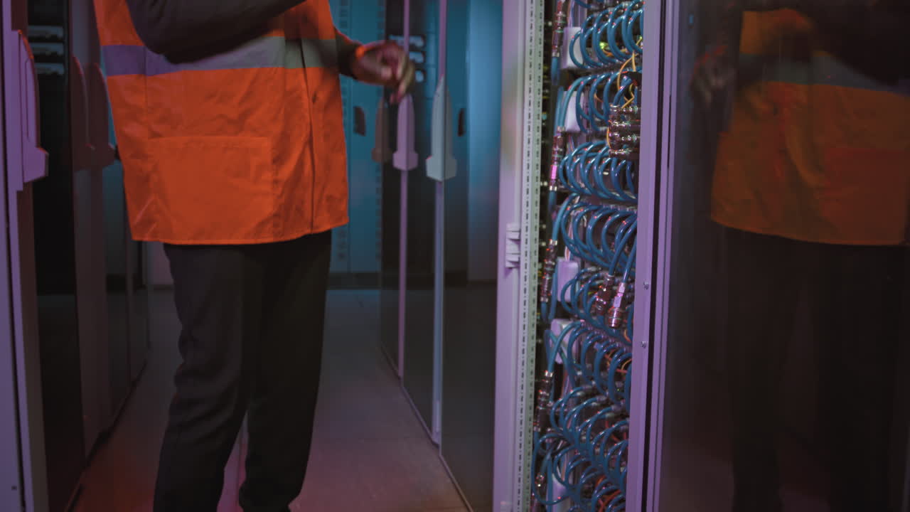 Technician Checking Equipment in Data Center