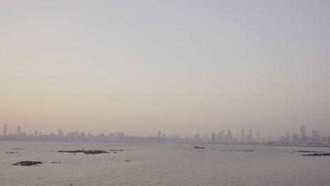 urban landscape of the coastal mumbai marine beach at dusk with skyline luxury buildings in the evening with poor air t, wide angle shot, india
