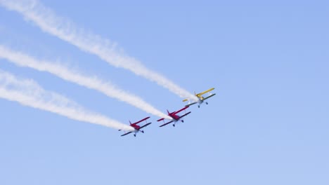 biplanes performing synchronized stunts in clear skies