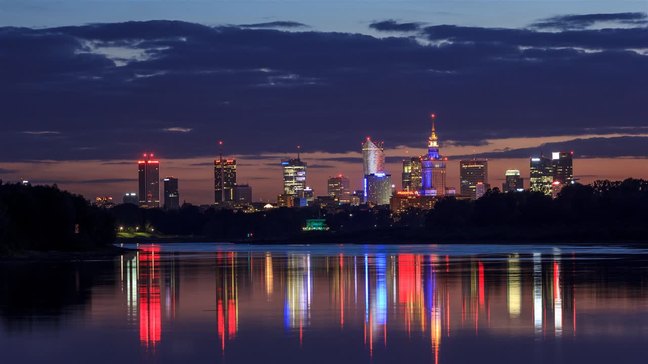 New moon setting behind beautiful cityscape in Warsaw, Poland over Vistula river.