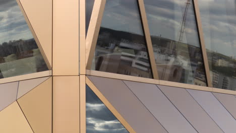 modern building facade detail with geometric patterns and glass reflections