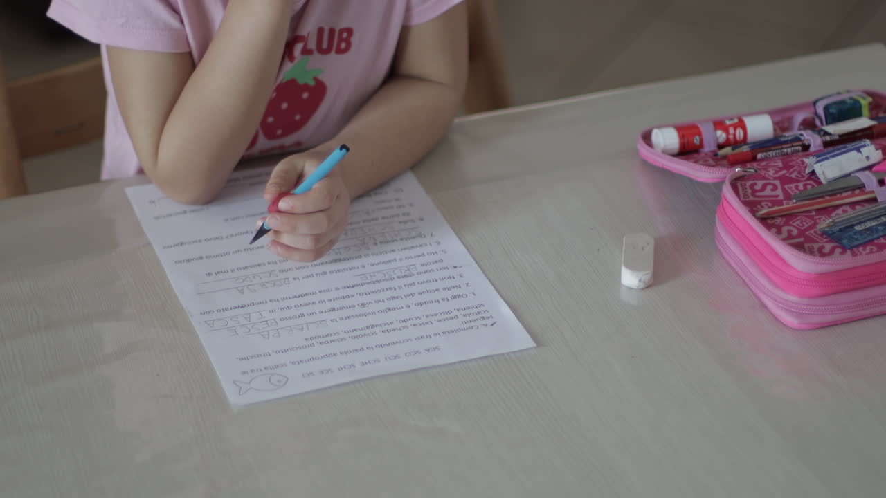 Cinematic detail of a child doing homework at home. Shot from above