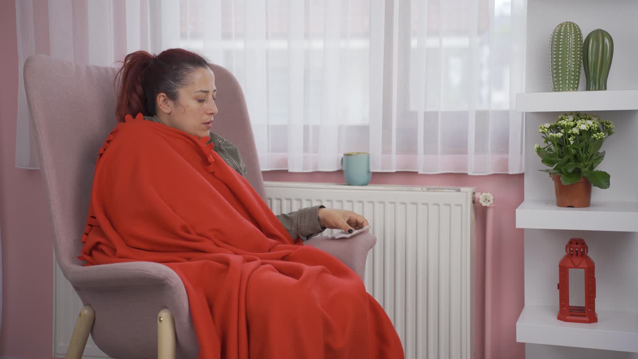 히터에 기대어 있는 여자는 차가워요.