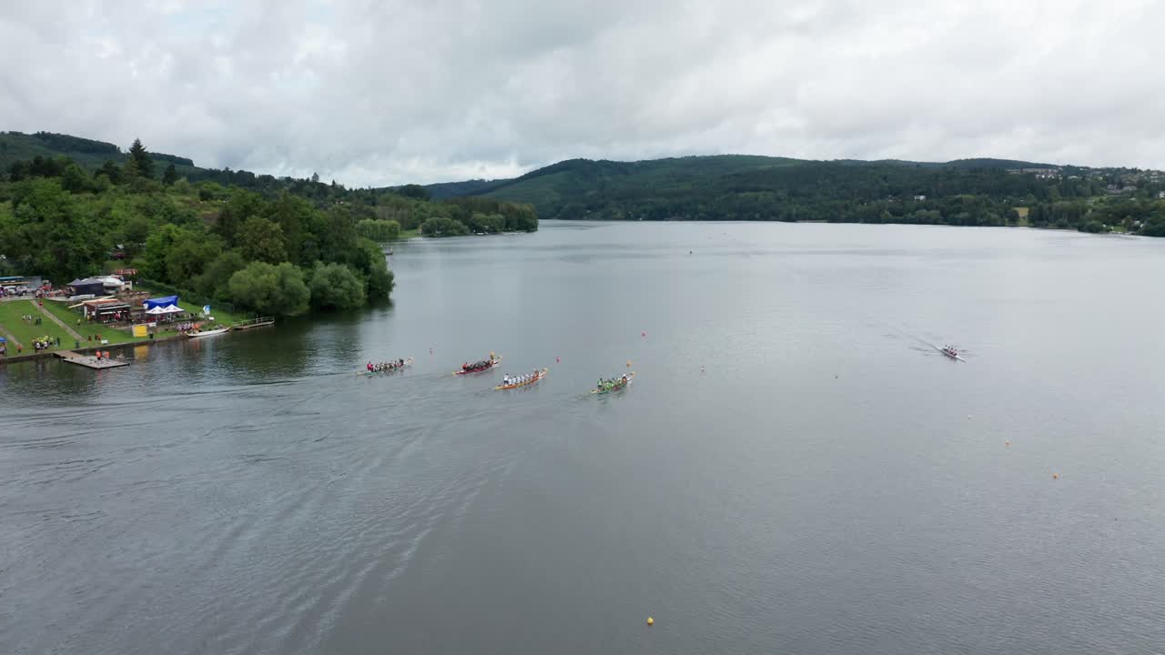 wide follow drone shot of race rowing boats on dam in brno city