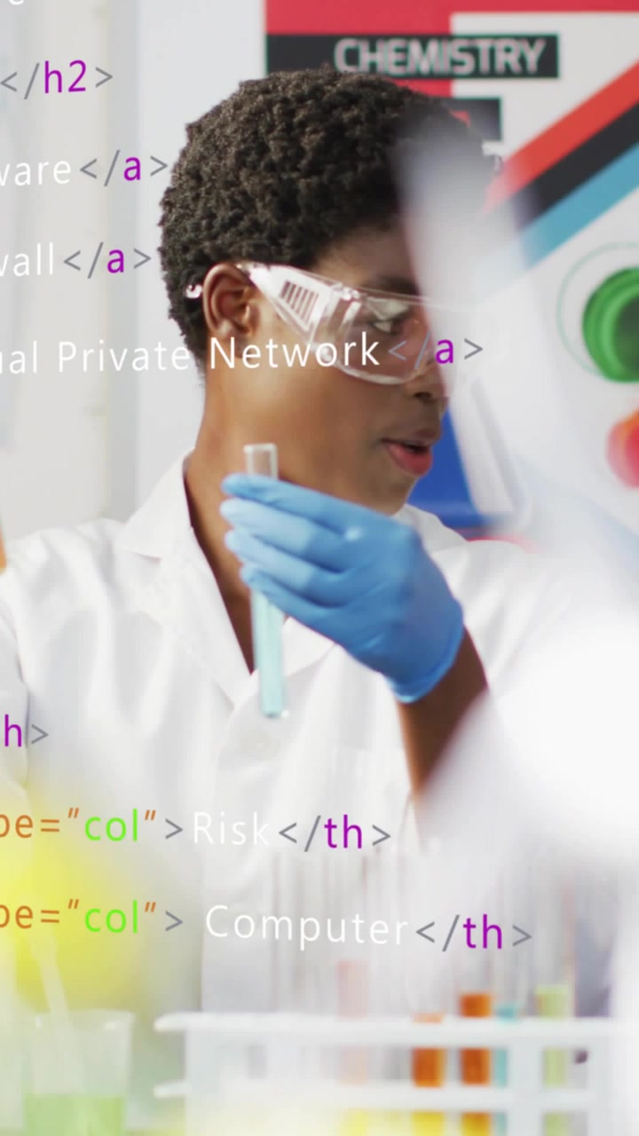 Vertical video: Male student lifting tubes in science lab, comparing colors as code overlay flowing