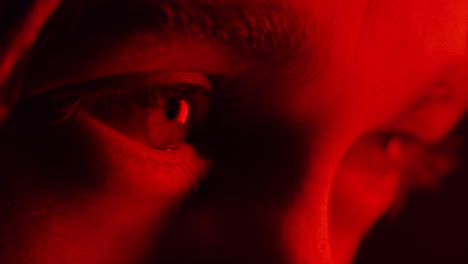 close up macro eyes opening looking at  intense red light