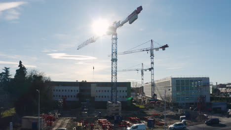 left to right aerial drone traveling of a crane in action construction site.