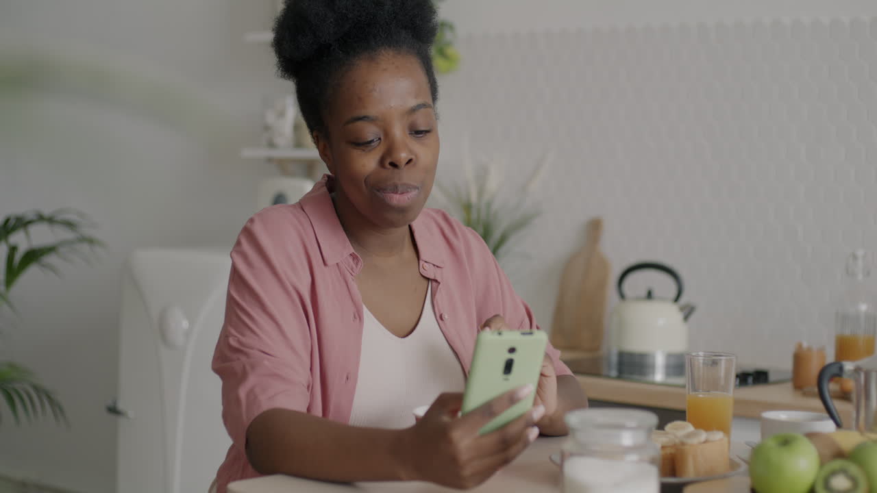 Woman Eating Breakfast and Using Phone